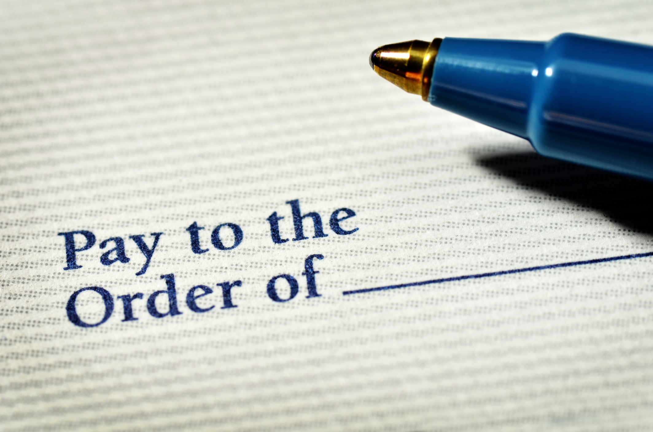 Check "pay to the order of" blank field with ink pen