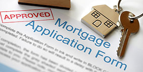 Mortgage application stamped in red with the word "Approved."