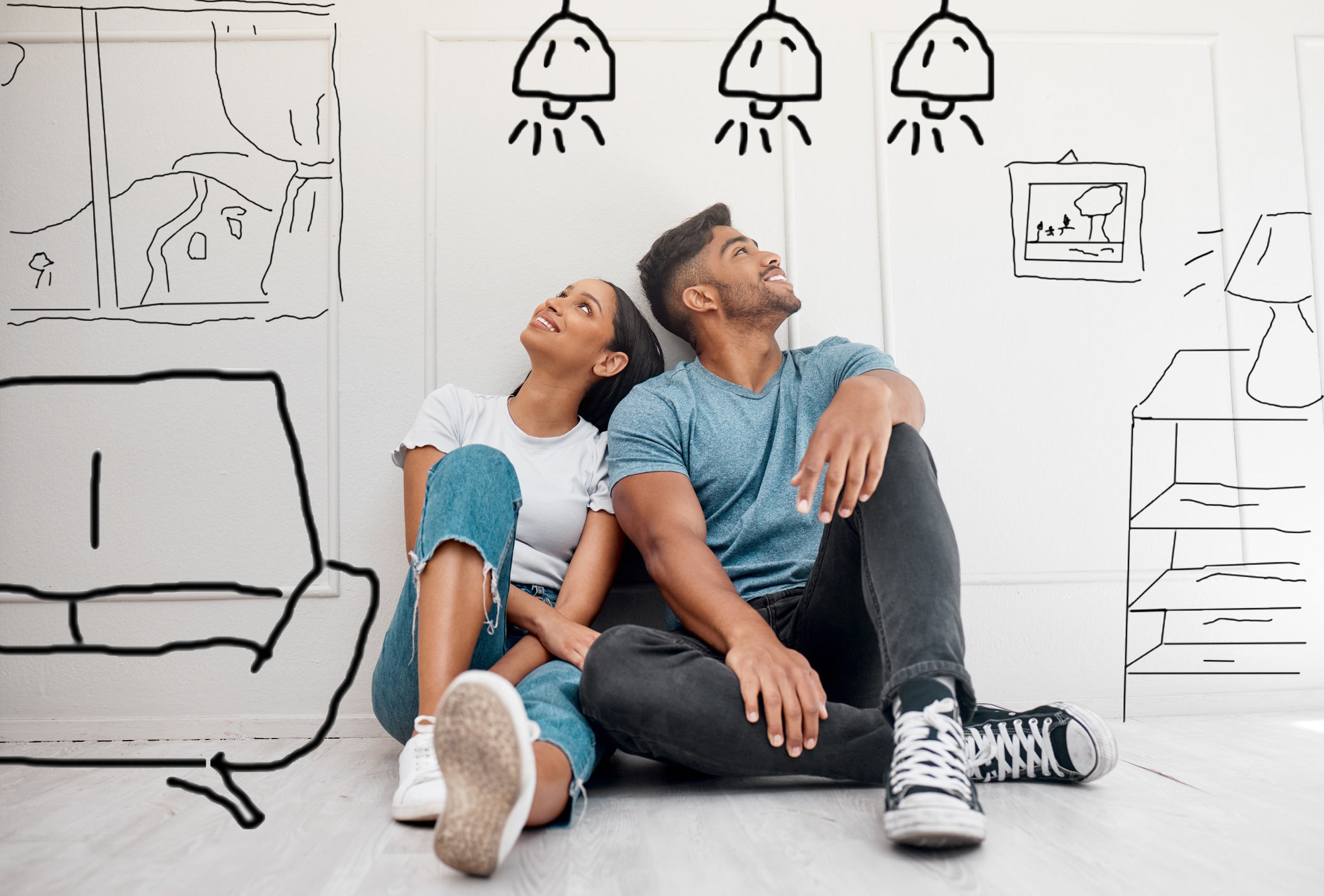 younger mixed couple with drawings of home decor ideas 