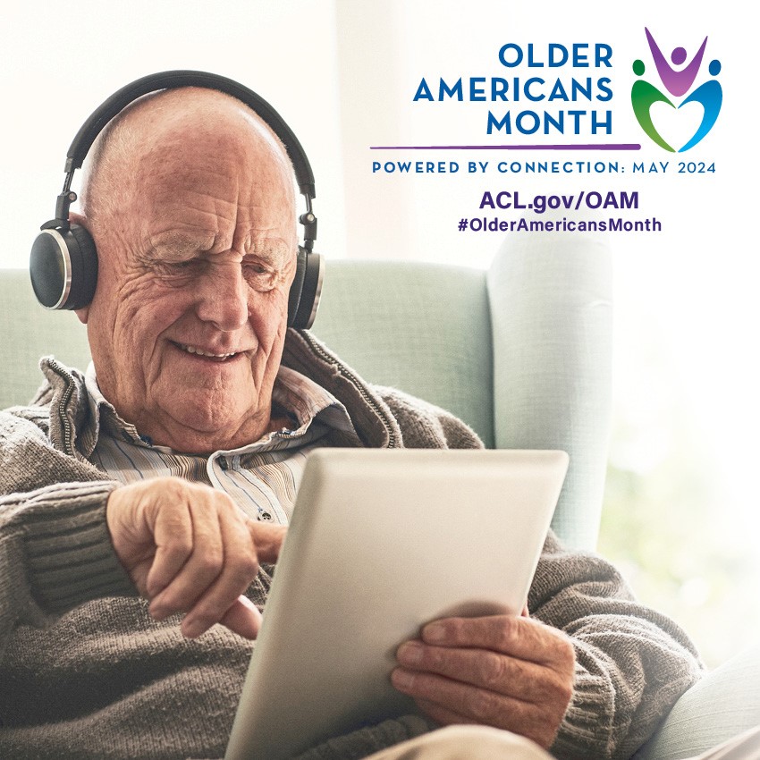 older americans month: older man with headphones on ipad