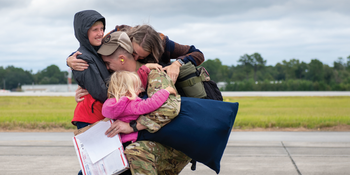 military family smiling and embracing