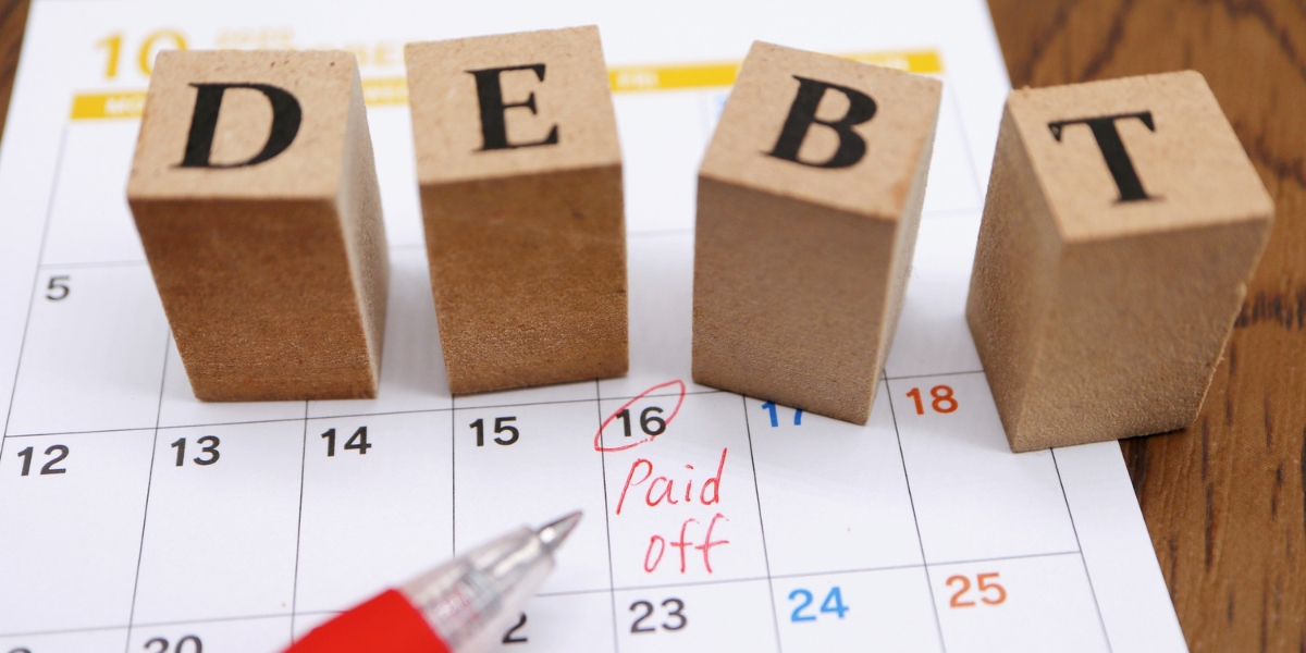 debt scrabble blocks on calendar