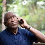 African american senior male listening to phone call