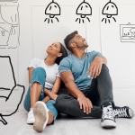 younger mixed couple with drawings of home decor ideas