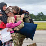 military family hugging