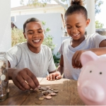 family throwing coins into a piggy bank together