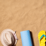 sand with hat and flips flops on it