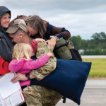 military family smiling and embracing