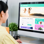 girl looking at computer with a fake travel website