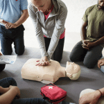 people doing CPR on mannequin