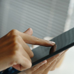 hand tapping with finger on screen