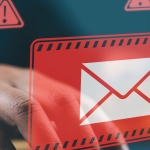 hands typing on keyboard with red alert